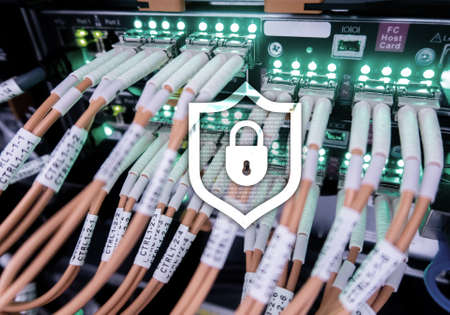 Cyber protection shield icon on server room background. Information Security and virus detection.の写真素材