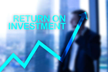 ROI - Return on investment. Stock trading and financial growth concept on blurred business center background.の写真素材