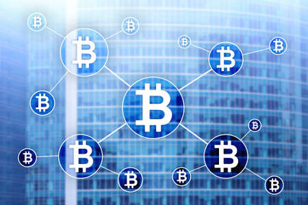 Bitcoin cryptocurrency and blockchain technology concept on blurred skyscrapers background.の写真素材