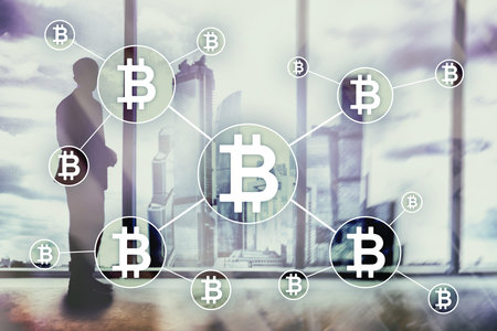 Bitcoin cryptocurrency and blockchain technology concept on blurred skyscrapers background.
