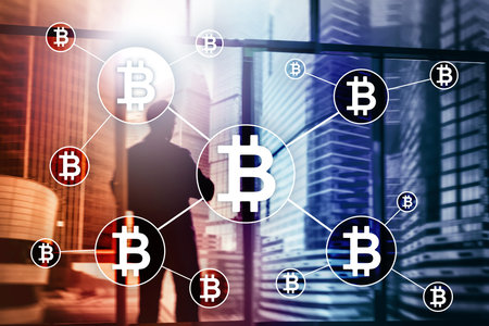 Bitcoin cryptocurrency and blockchain technology concept on blurred skyscrapers background.