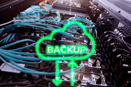 Backup button on modern server room background. Data loss prevention. System recovery.の写真素材