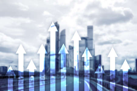 Up arrow graph on skyscraper background. Invesment and financial growth concept.の写真素材