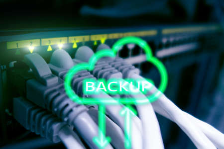 Backup button on modern server room background. Data loss prevention. System recovery.