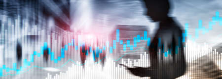 Stock trading candlestick chart and diagrams on blurred office center background.