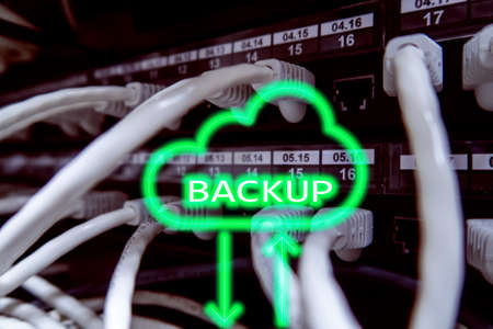 Backup button on modern server room background. Data loss prevention. System recovery.の写真素材
