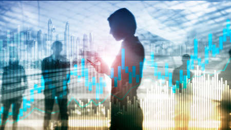 Stock trading candlestick chart and diagrams on blurred office center background.