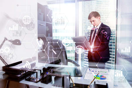 Double exposure mixed media. Diagrams and icons on hologram screen. Business people and modern city on background.の写真素材