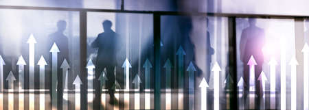 Up arrow graph on skyscraper background. Invesment and financial growth concept.の写真素材