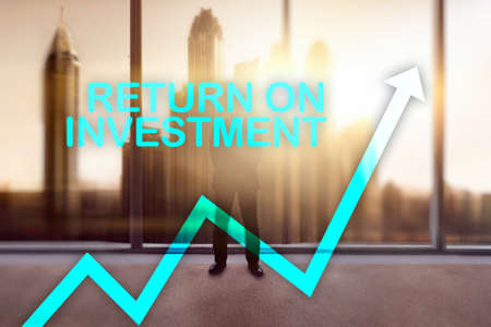 ROI - Return on investment. Stock trading and financial growth concept on blurred business center background.の写真素材