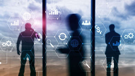 Double exposure mixed media. Diagrams and icons on hologram screen. Business people and modern city on background.の写真素材