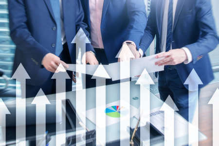 Up arrow graph on skyscraper background. Invesment and financial growth concept.の写真素材