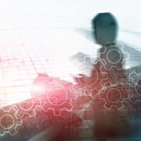 Double exposure gears mechanism on blurred background. Business and industrial process automation concept.の写真素材