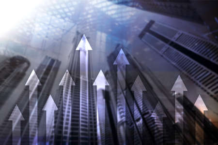 Up arrow graph on skyscraper background. Invesment and financial growth concept.の写真素材