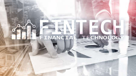 FINTECH - Financial technology, global business and information Internet communication technology. Skyscrapers background. Hi-tech business concept.の写真素材