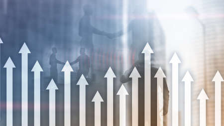Up arrow graph on skyscraper background. Invesment and financial growth concept.の写真素材