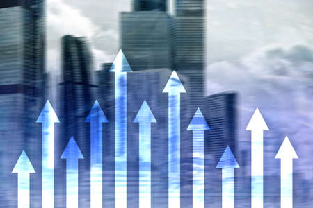 Up arrow graph on skyscraper background. Invesment and financial growth concept.の写真素材