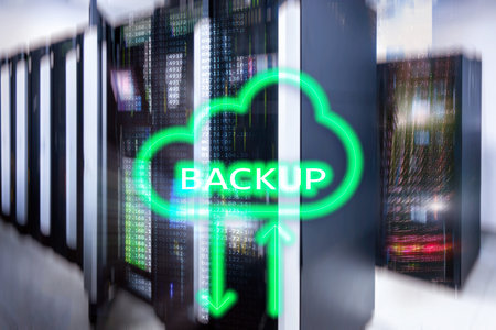 Backup button on modern server room background. Data loss prevention. System recovery.
