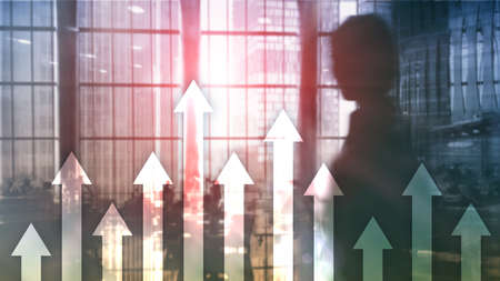 Up arrow graph on skyscraper background. Invesment and financial growth concept.の写真素材