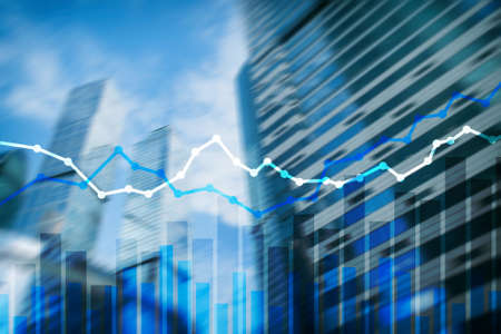 Double exposure financial graphs and diagrams. City backgroundの写真素材