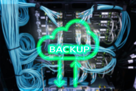 Backup button on modern server room background. Data loss prevention. System recovery.