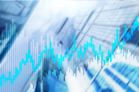 Stock trading candlestick chart and diagrams on blurred office center background.