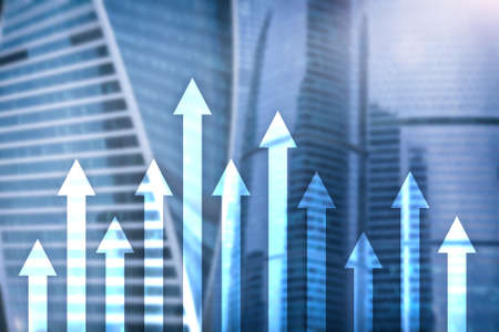Up arrow graph on skyscraper background. Invesment and financial growth concept.の写真素材