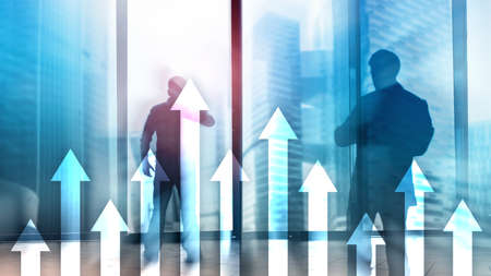Up arrow graph on skyscraper background. Invesment and financial growth concept.の写真素材