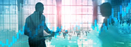 Stock trading candlestick chart and diagrams on blurred office center background.