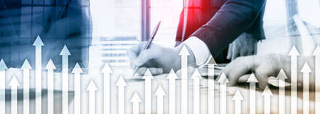 Up arrow graph on skyscraper background. Invesment and financial growth concept.の写真素材