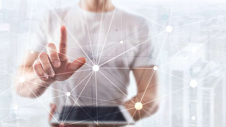 Blockchain network on blurred skyscrapers background. Financial technology and communication concept.の写真素材