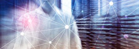 Blockchain network on blurred skyscrapers background. Financial technology and communication...