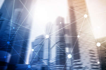 Blockchain network on blurred skyscrapers background. Financial technology and communication conceptの写真素材