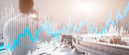 Stock trading candlestick chart and diagrams on blurred office center background.