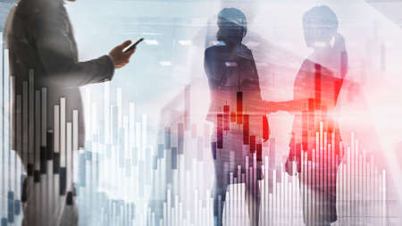 Candles and stock market charts on abstract background. Silhouettes and modern city.