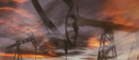 Oil derricks against the sky. Oil rig pump double exposure.