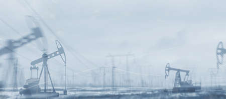 Oil derricks against the sky. Oil rig pump double exposure.の写真素材