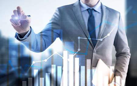 Businessman drawing graph with marker on media screen.の写真素材