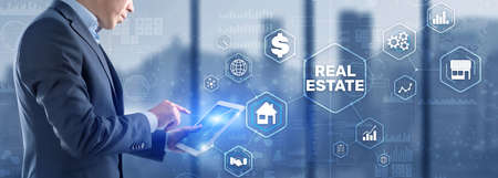Real estate investment. Businessman pressing on virtual screensの写真素材