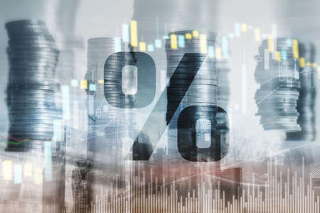 Percentage icon on financial stock market background. Double exposure of stack of coins and cityの写真素材