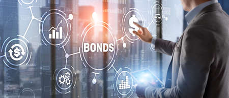 Businessman clicks a bonds virtual screen. Bond Finance Banking Technology concept. Trade Market Networkの写真素材