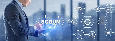 SCRUM. Hand presses the inscription scrum on a virtual panel. Agile development methodologyの写真素材