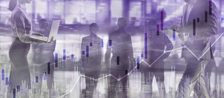 Trading candlestick chart and diagrams on blurred office center background peopleの写真素材