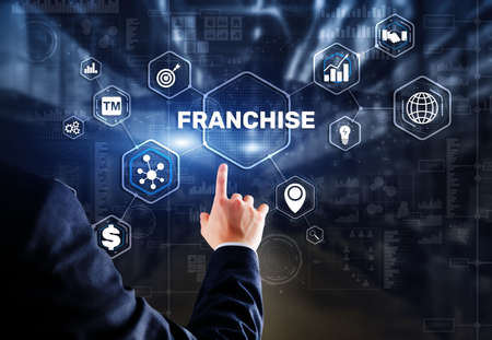 Businessman hand touching inscription Franchise marketing systemの写真素材