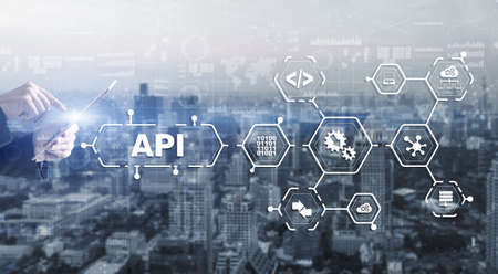 Application Programming Interface. API software development tool. Information technology concept. Businessman presses API text icon on a virtual interfaceの写真素材