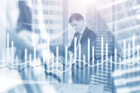 Bar graph on the background of a business center with a manager at the windowの写真素材