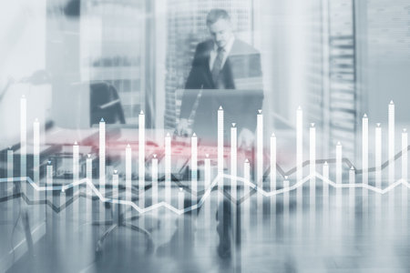 Bar graph on the background of a business center with a manager at the windowの写真素材