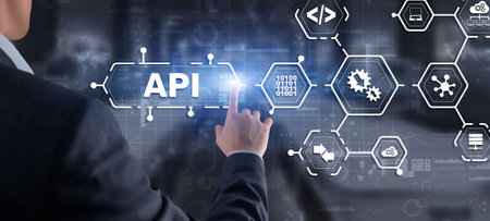 Application Programming Interface. API software development tool. Information technology concept. Businessman presses API text icon on a virtual interfaceの写真素材