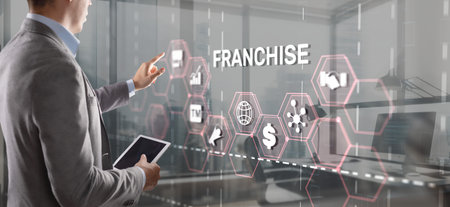 Businessman hand touching inscription Franchise marketing systemの写真素材