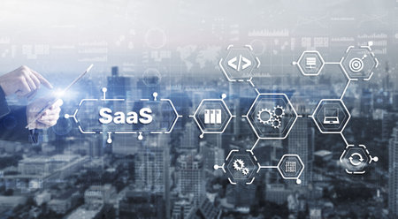 SaaS Software as a Service concept with man hand pressing textの写真素材